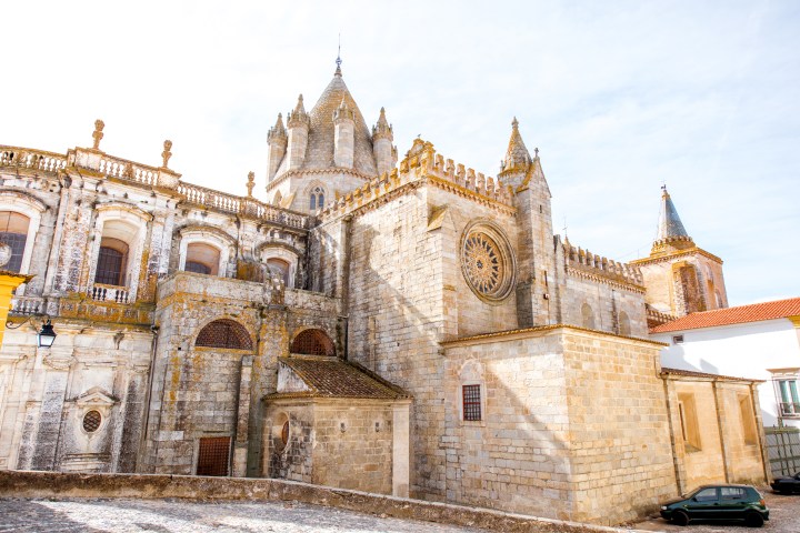 Historic cathedral with intricate stonework and tall spires under a clear sky